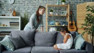 girl-sitting-and-breaking-down-on-sofa-mother-convincing