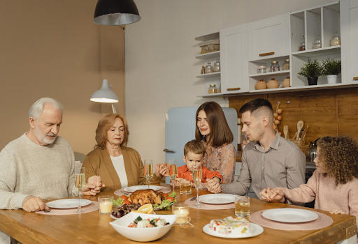 A whole family sitting on dining table together 