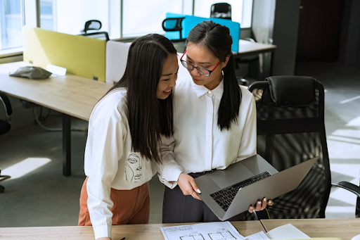 Work colleagues looking at laptop to discuss potential cybersecurity issue.