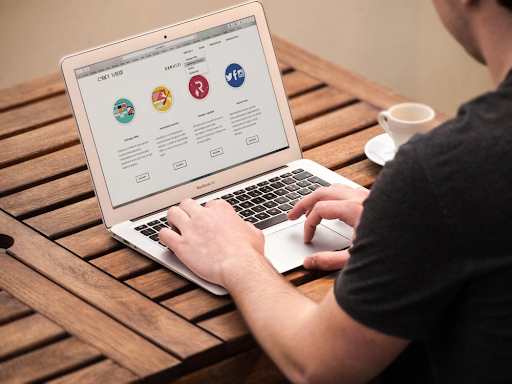 Employee exploring new online work platform and information on personal laptop.
